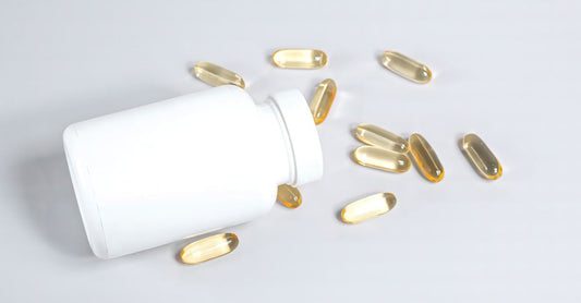 Choline for brain health supplement bottle next to a glass of water on a clean surface