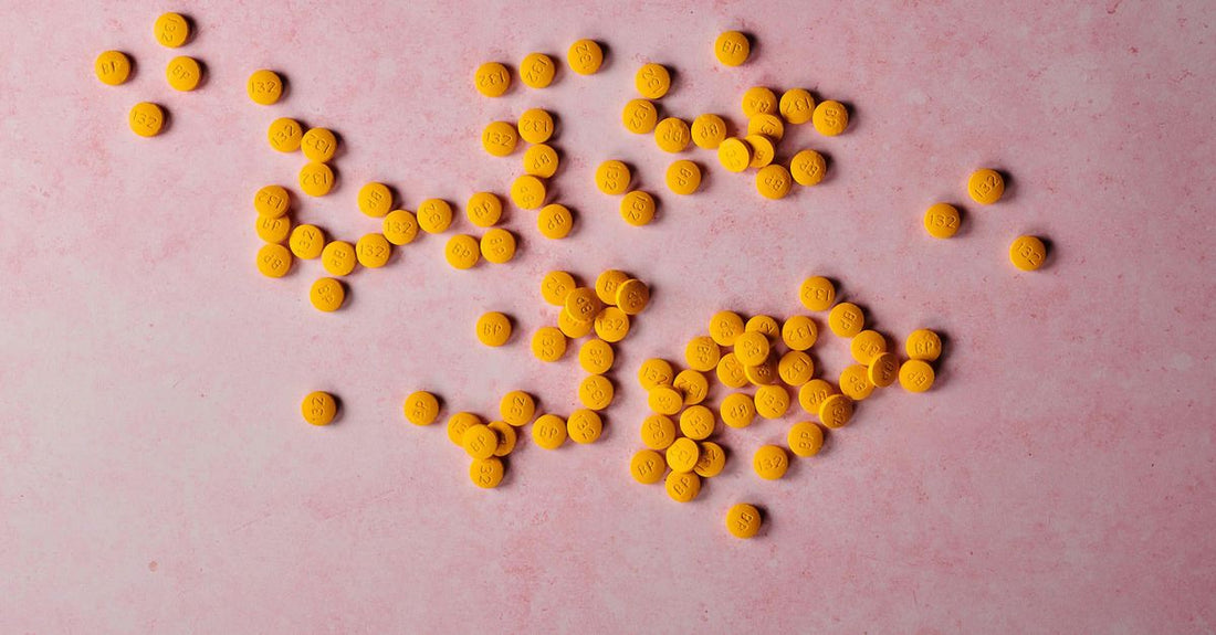 A flatlay of best everyday vitamins & supplements 2026 including multivitamin, omega-3, vitamin D, magnesium and probiotic bottles.