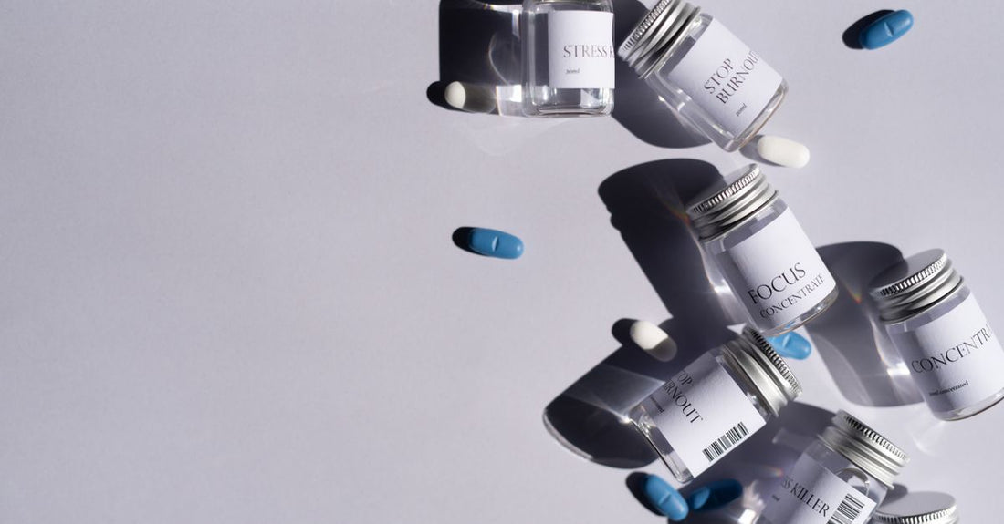 A flatlay of everyday vitamins and supplements bottles arranged on a light surface, showing how to choose everyday vitamins & supplements.