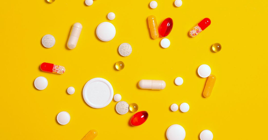 Assorted everyday vitamin and supplement bottles arranged on a white surface, showcasing how to choose everyday vitamins and supplements for a balanced routine.