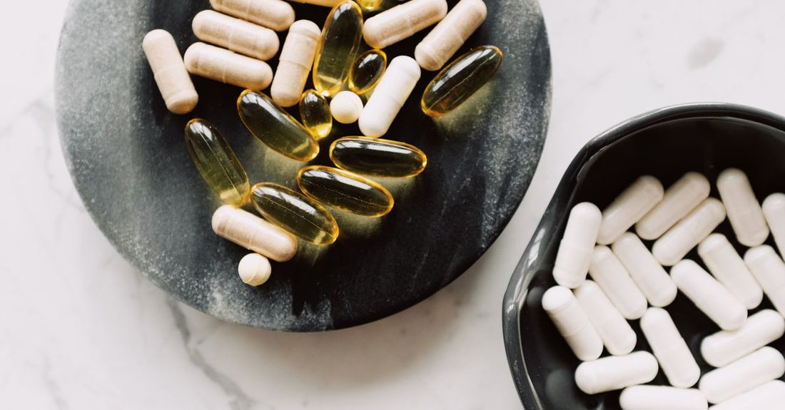 Assorted everyday vitamin and supplement bottles arranged on a light surface, representing an everyday vitamins & supplements buying guide for Australian shoppers