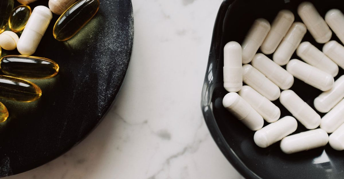 Assorted everyday vitamins and supplements bottles arranged on a clean surface for a buying guide