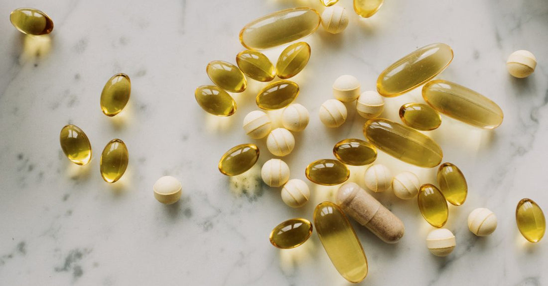 An assortment of the best everyday vitamins and supplements for 2026 arranged on a light surface, representing a thoughtful daily wellness gift.