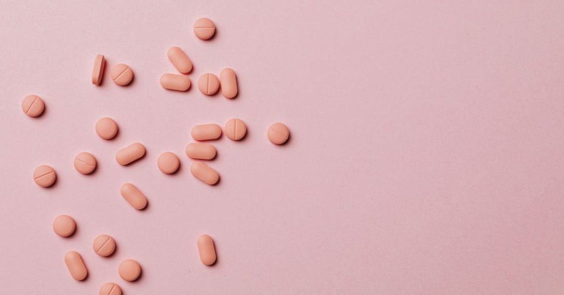 Flatlay of everyday vitamins and supplements including capsules and softgels on a neutral background, representing our buying guide for 2026.