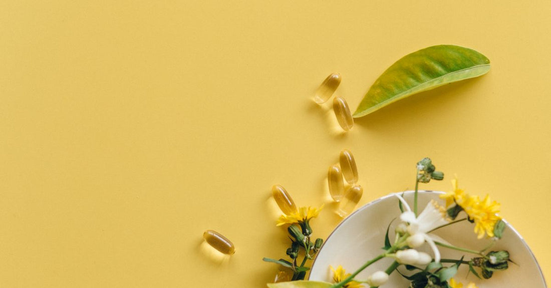 A flatlay of best everyday vitamins & supplements 2026 including multivitamin, probiotic, and omega-3 bottles on a light spring backdrop.