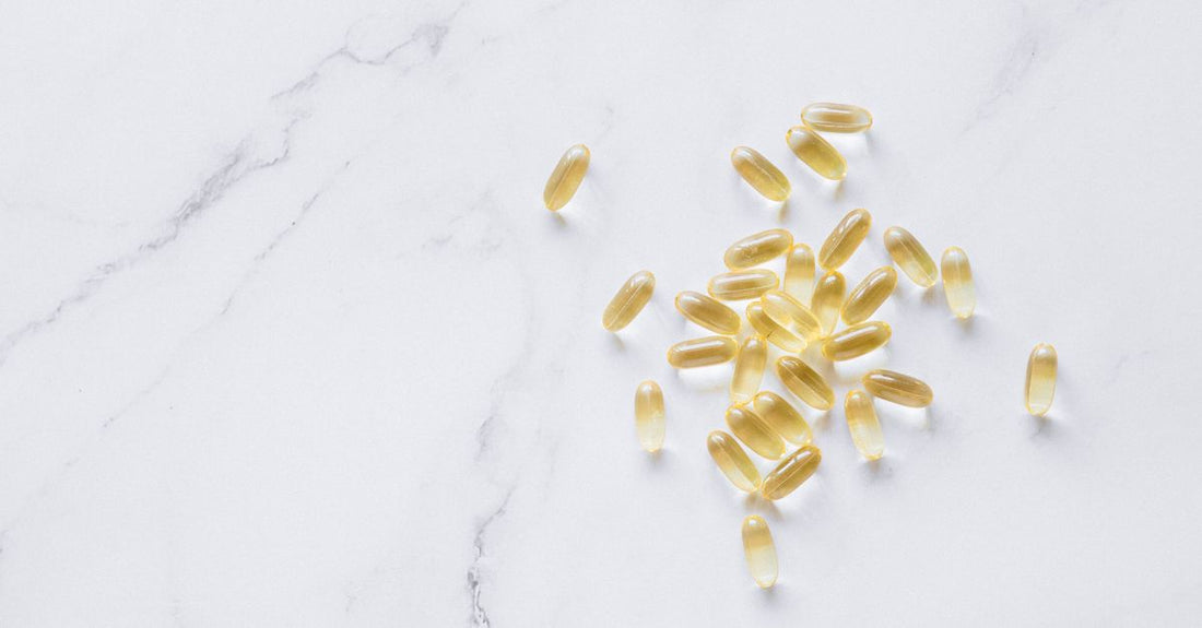 Everyday vitamins & supplements buying guide featuring a flatlay of supplement bottles on a bright surface.