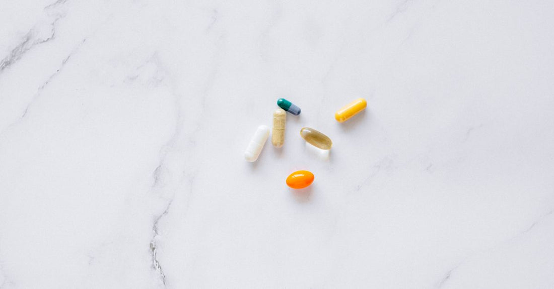 Assortment of everyday vitamins and supplements bottles on a clean surface, representing a buying guide selection.