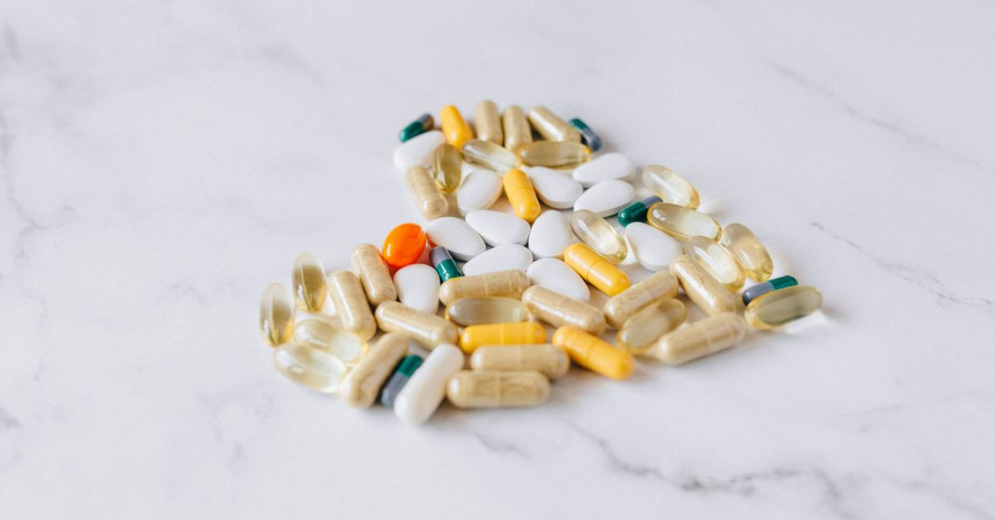 Colourful everyday vitamin and supplement capsules arranged on a clean white surface, representing how to choose the right daily nutrients in Australia.