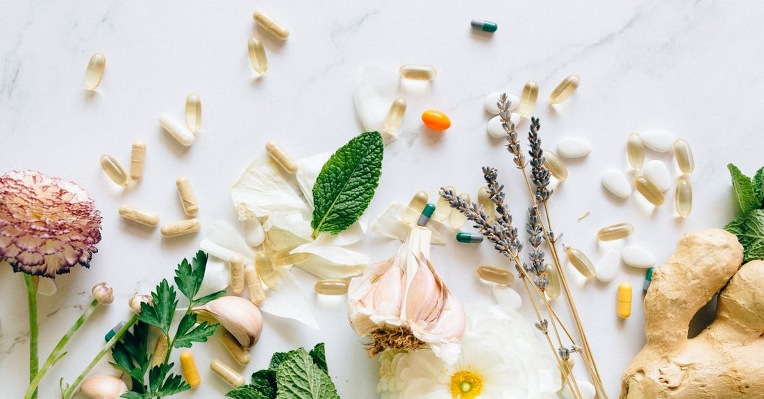 A flatlay of everyday vitamins and supplements including multivitamins, fish oil, and magnesium on a light background, illustrating how to choose everyday vitamins & supplements.