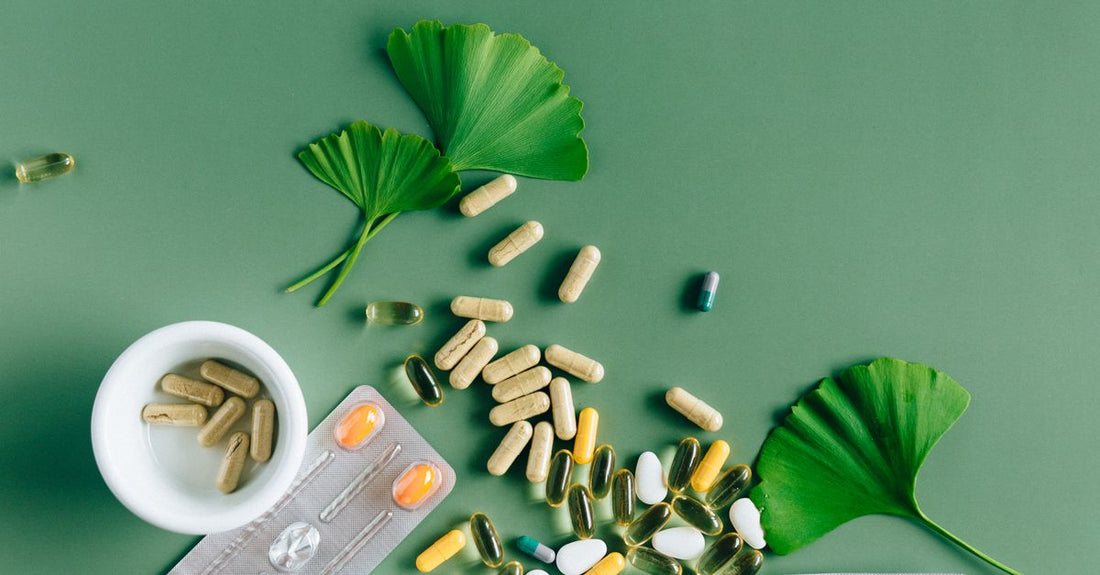 An everyday vitamins & supplements buying guide flatlay showing assorted capsules and tablets on a light surface, representing a balanced daily health routine.