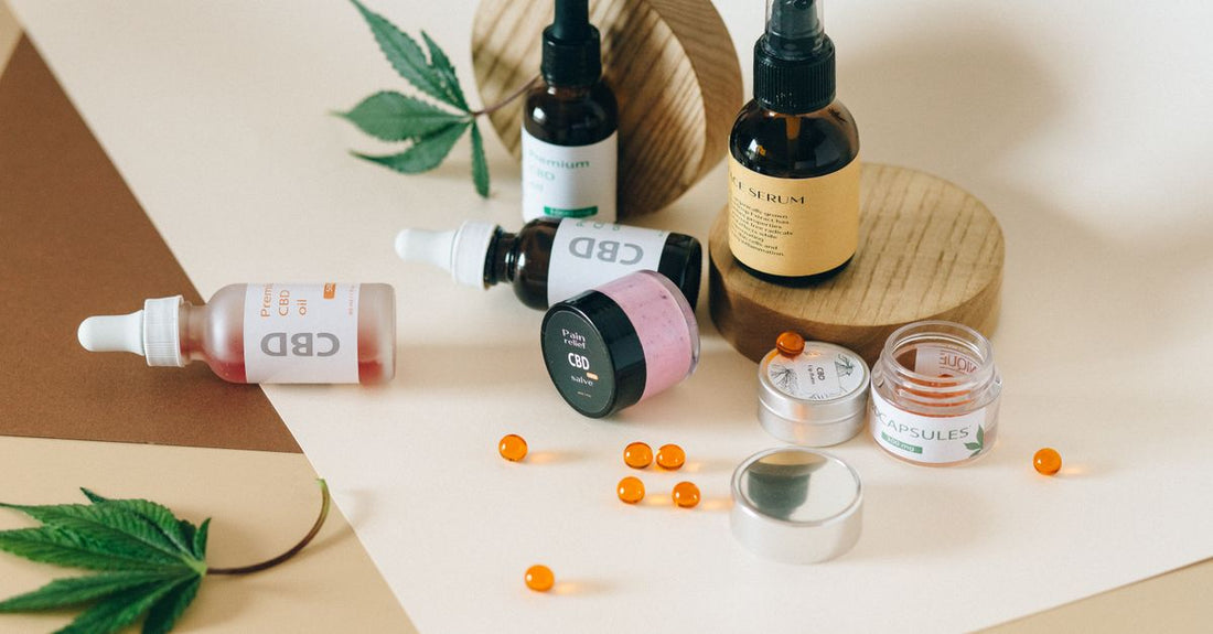 An assortment of everyday vitamin and supplement bottles arranged on a clean surface, illustrating how to choose everyday vitamins & supplements for a daily routine.