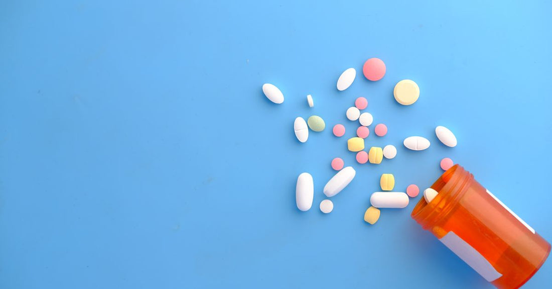 A flatlay of everyday vitamins and supplements bottles on a marble surface, illustrating an everyday vitamins & supplements buying guide for Australian shoppers.