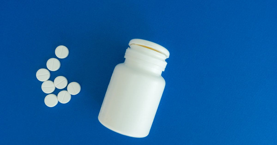 Colourful vitamin and supplement bottles neatly arranged on a white shelf, showing where to buy everyday vitamins & supplements online in Australia.