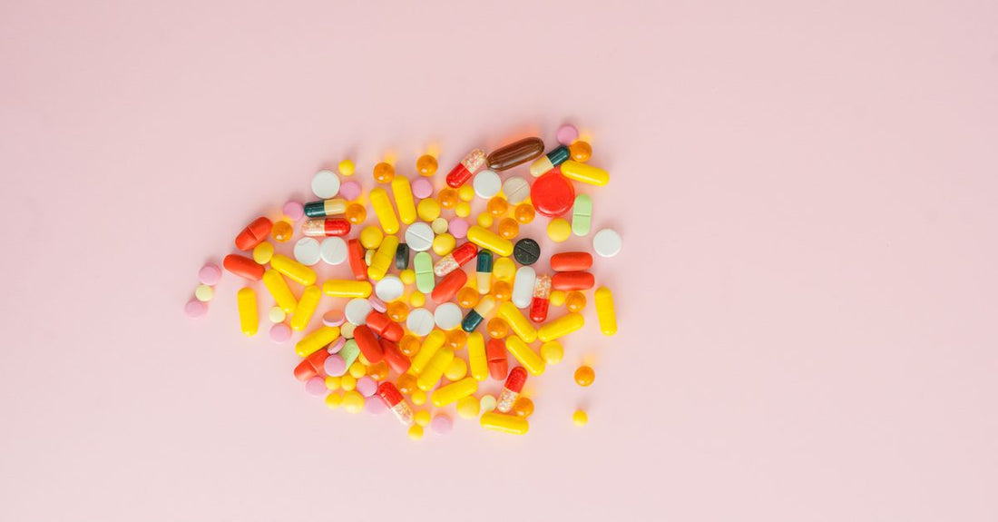 Colourful assortment of everyday vitamins and supplements bottles arranged on a white surface, representing where to buy everyday vitamins & supplements online in Australia.